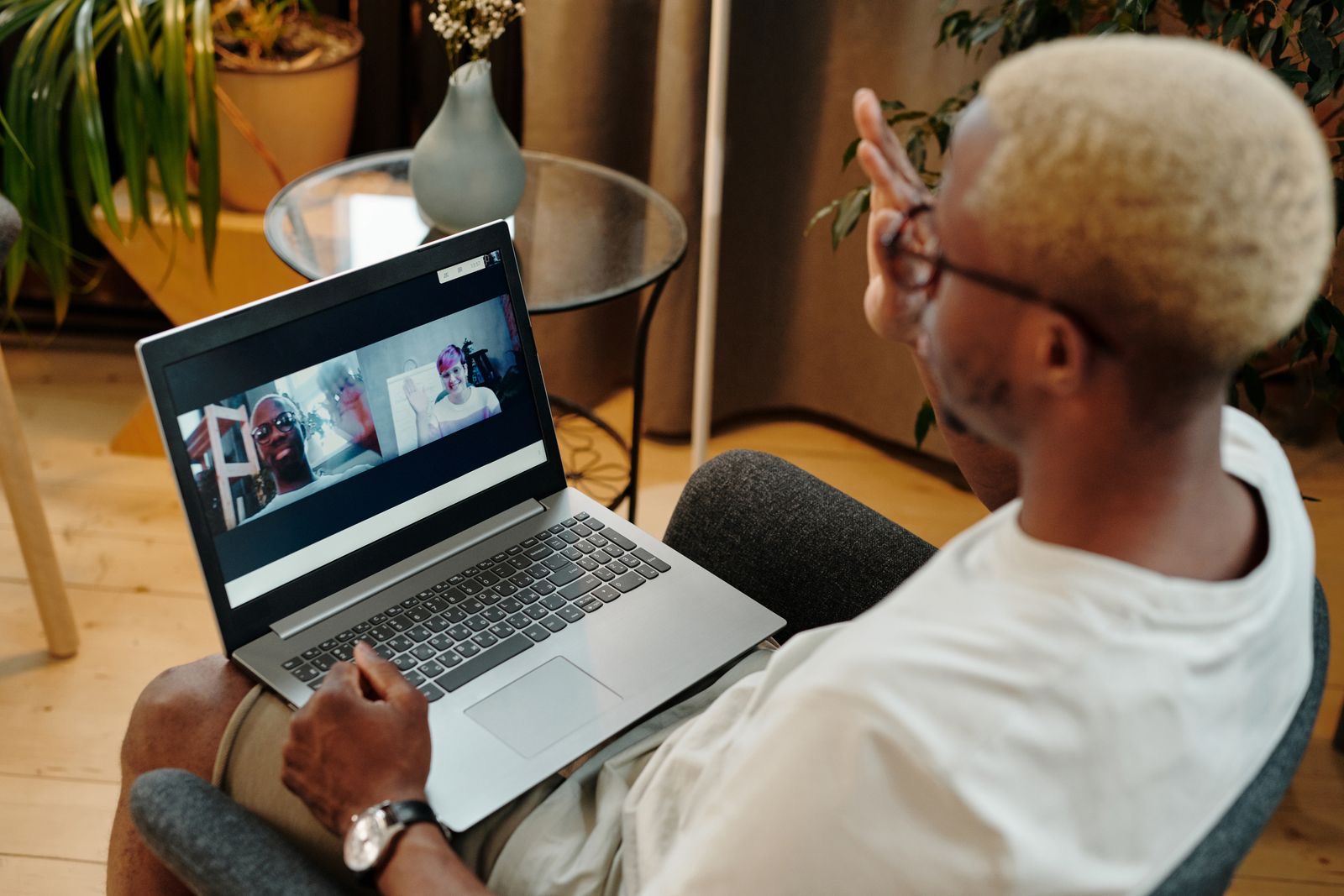 A person on a video call at a laptop