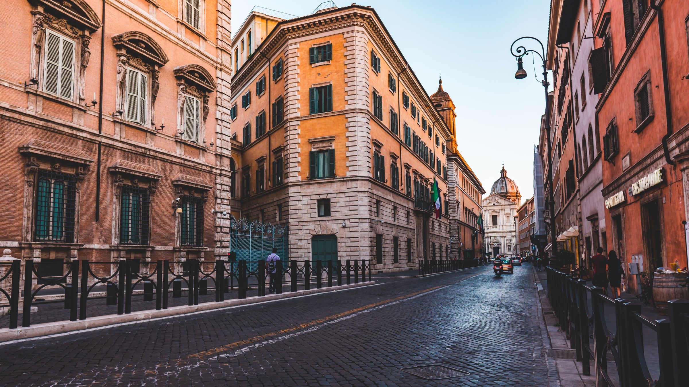 Document binder and papers on an office desk by a window in Rome