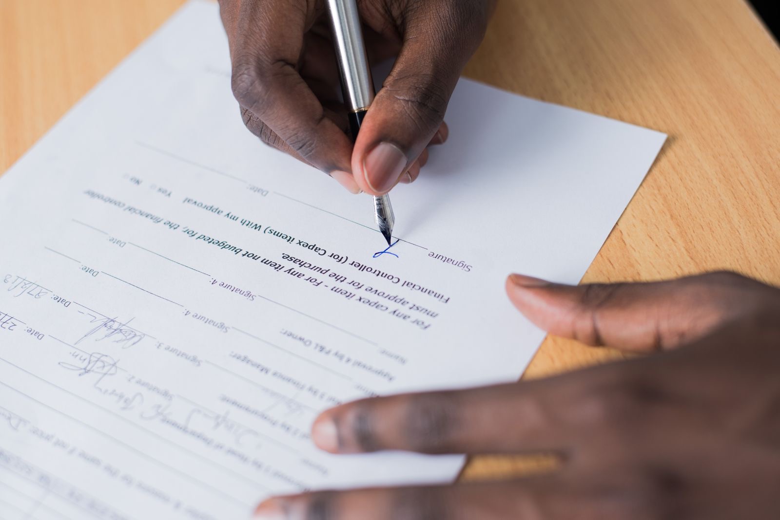 A signed deed and a pen on a notary's desk