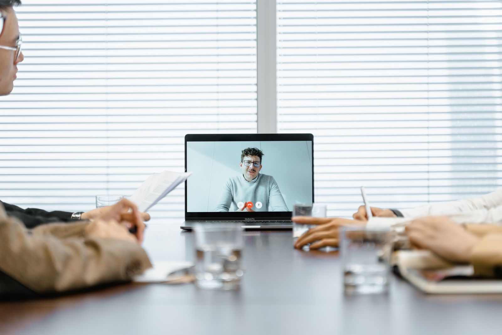 A founder signing a document during a video call on a laptop