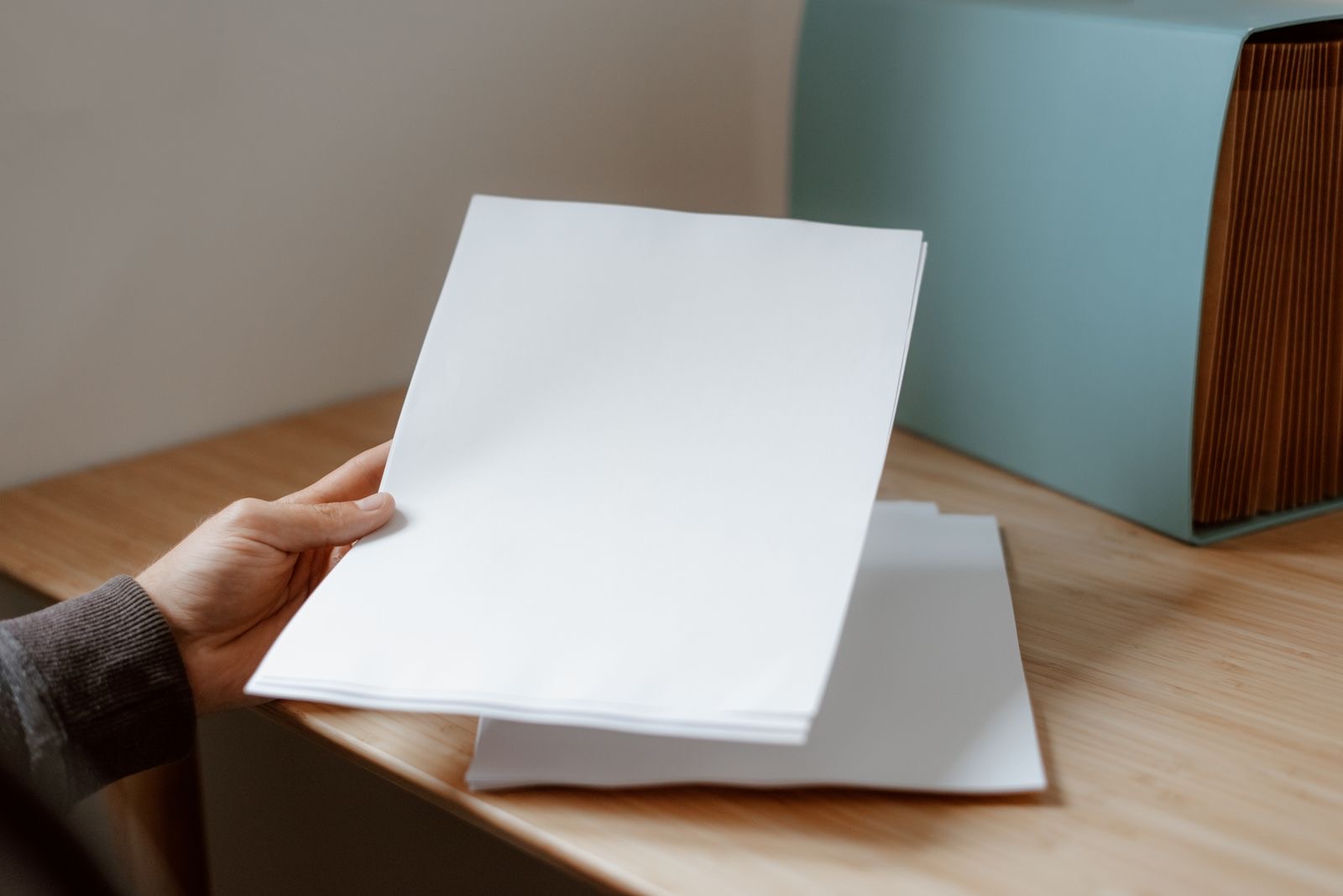 A passport folder and papers on a desk, as prepared for a consulate appointment