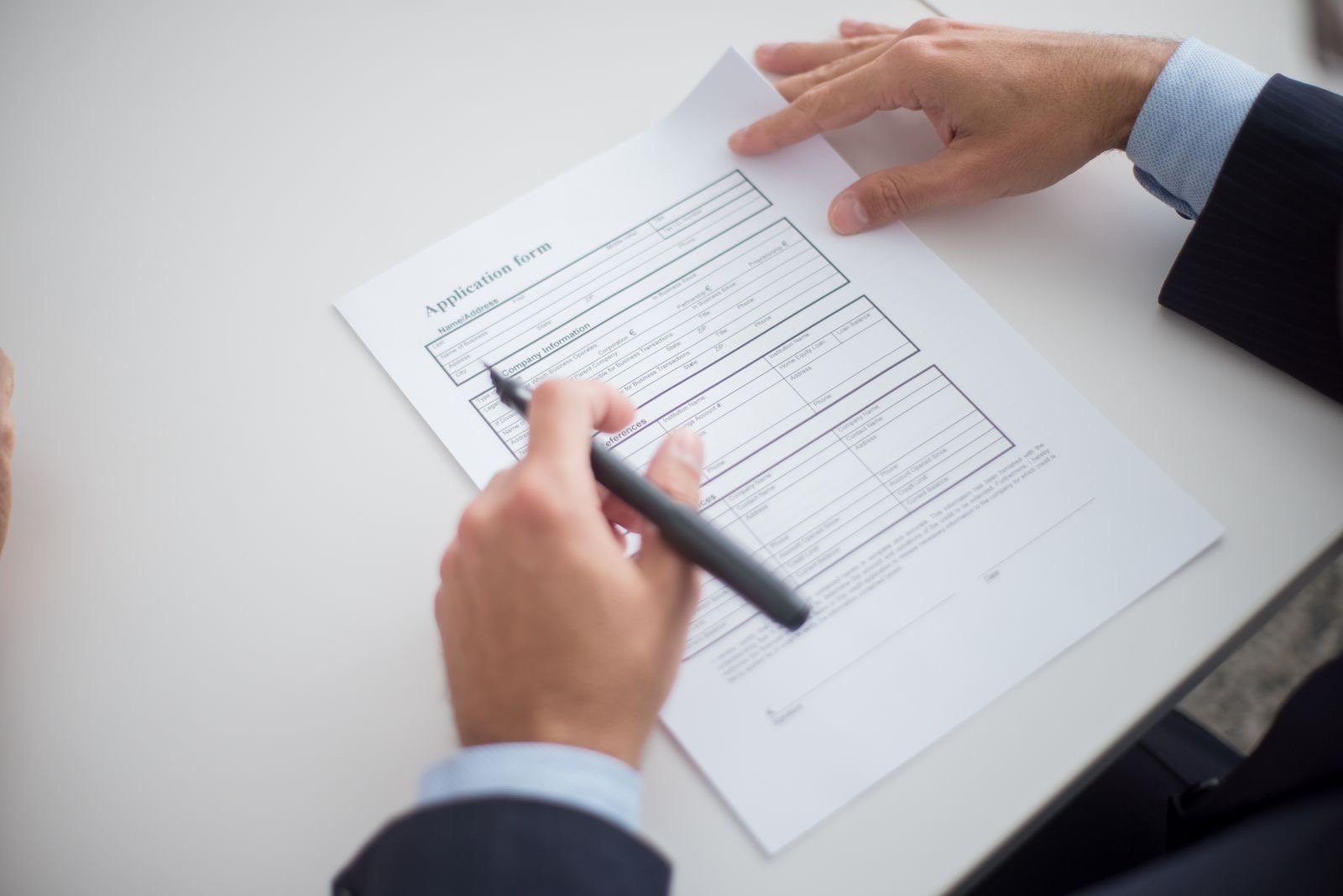 Application documents and photographs laid out on a desk