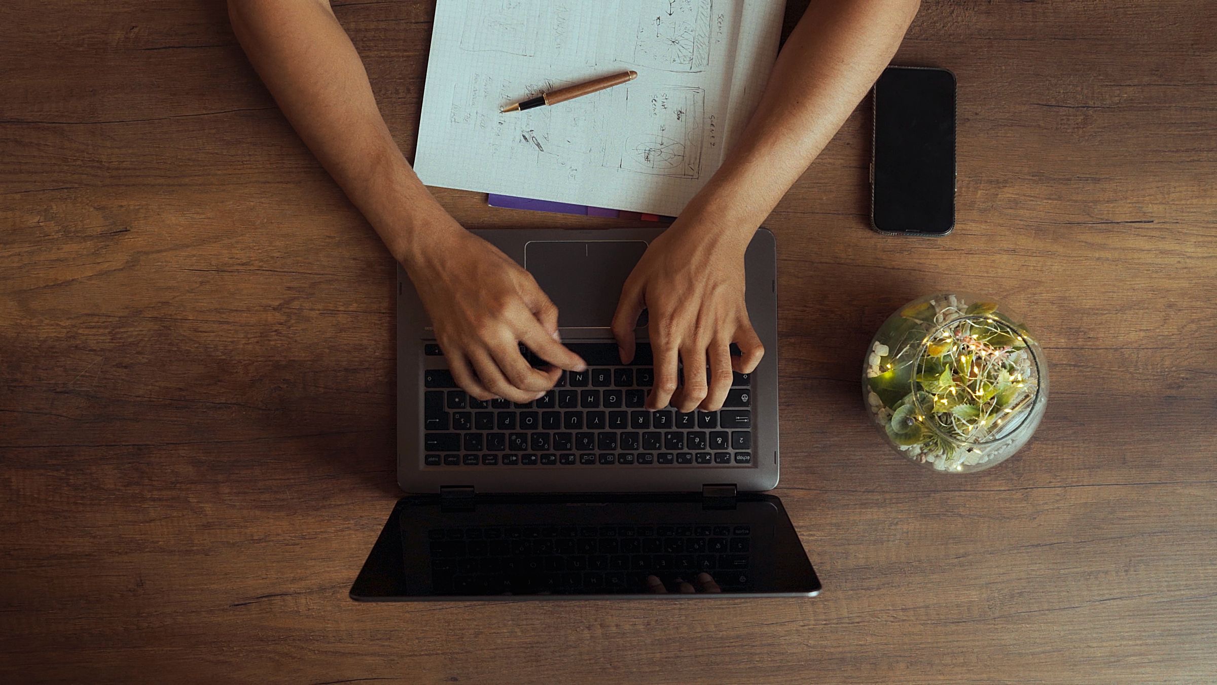 A laptop and a folder of company papers on a desk, prepared for an Italian VAT filing