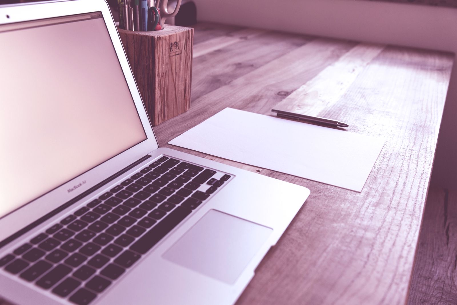 A notary's desk with a laptop and a folder of documents
