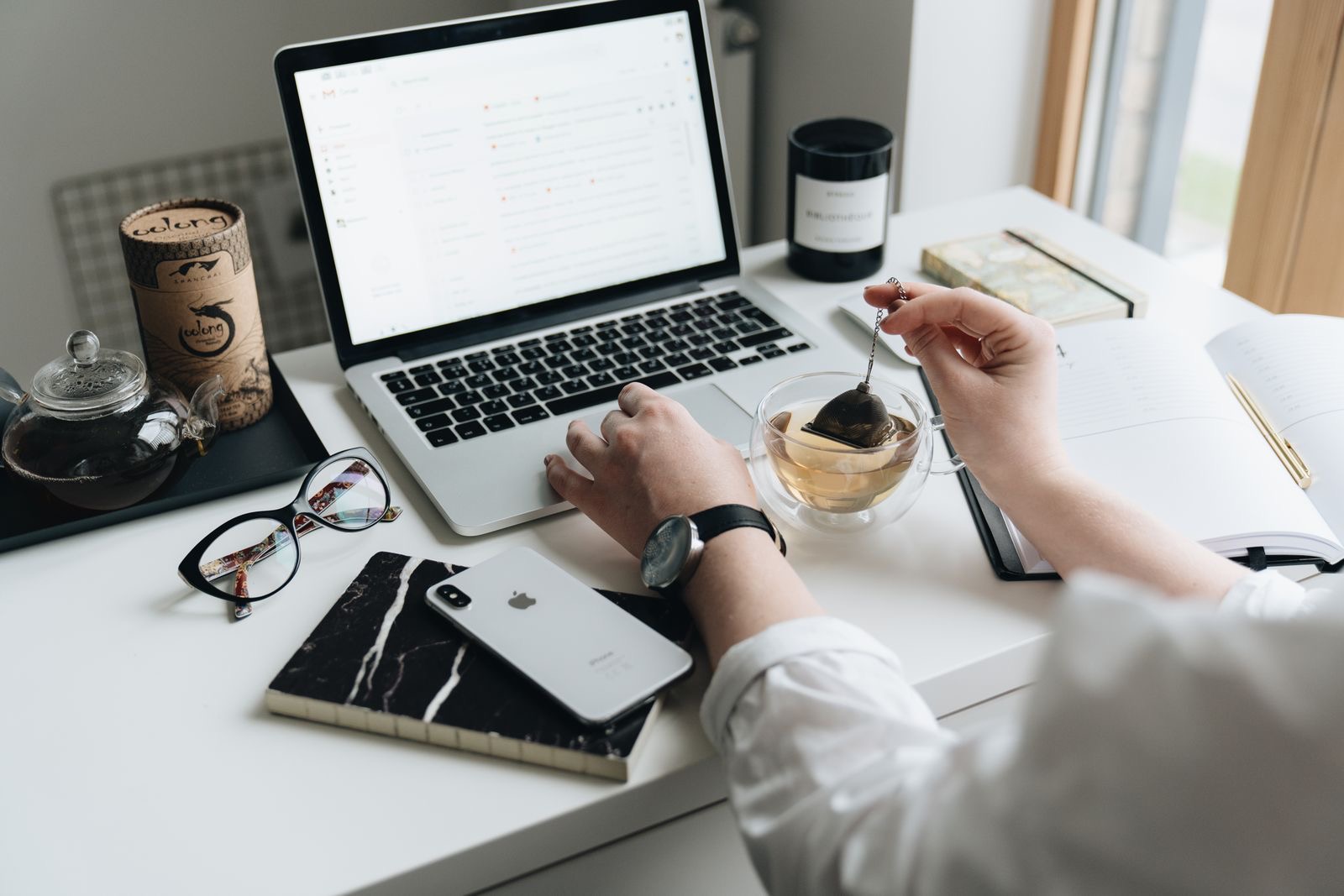 A person typing on a laptop at a desk